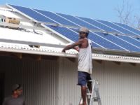 Tom Nombong installing 30 solar panels on the roof of the pavilion